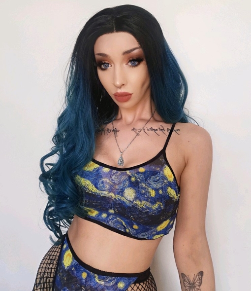 Apatite has black roots that grow into a blueish green ombre. The lengths are long with cascading curls, falling past the waist. Add your own look with dressing and styling. A lace front wig for a realistic hairline.