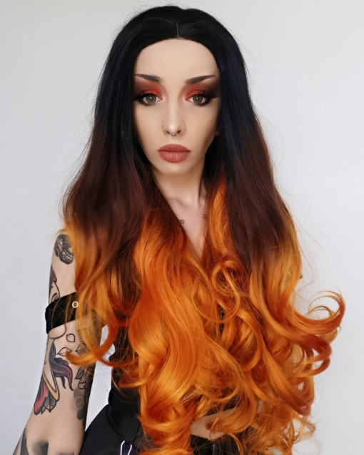 Long curly orange lace front wig. Crush is certainly what we have on this wig, with its cascading curls. Cool black sleek roots, melt into a bronze and blend in a burnt orange ombre.