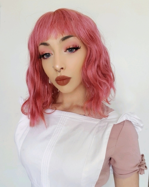 Pink wavy bob wig with bangs. Bonbon is giving us a sugar-rush of deep pink hues. This cute look is styled, in loose beachy waves for body and texture.