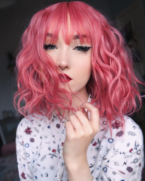 Bubble gum pink gives us Bon bon from roots to tips. Textured tousled waves are lightweight and manageable. This bob falls just above the shoulders with a blunt fringe to finish the look.