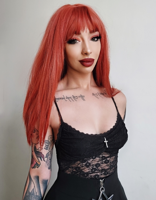 Burnt orange long straight wig with bangs. This vivid colour is an instant hit! Lava has shades of deep burnt sunshine orange colours, this thick sleek look.
