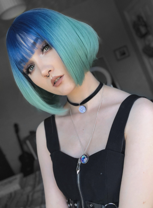 Tide takes to tones of blue, with sky blue roots, meting into an aqua colour. This short sleek bob curls under for body and volume. A light fringe frames the face, manageable and easy to wear.