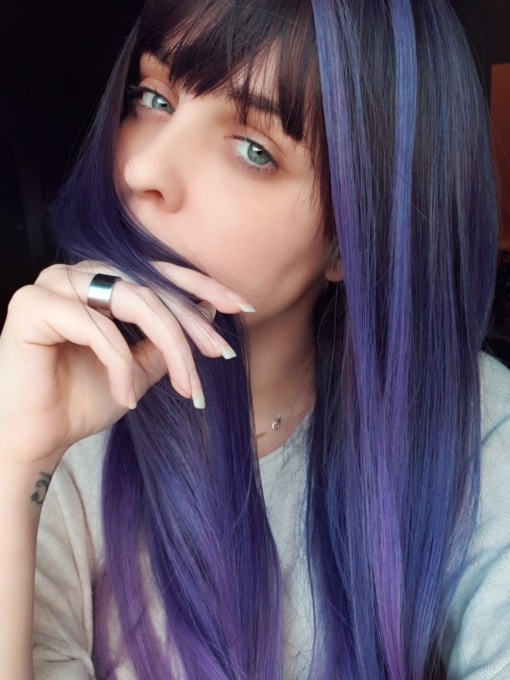 Dusky blue and purple long straight wig with bangs. Go intergalactic! Galaxy has a mix of muted navy and lilac undertones, with a pink dip dye effect. Dark shadowed roots gives a natural feel to the look.