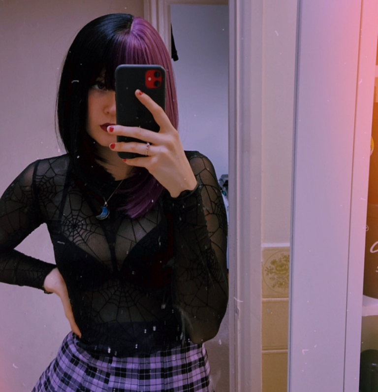 Nova takes on the dramatic colour divide. Gothic mix of purple and black colours. Split down the centre parting and carrying the colour through the sleek fringe. Styled into a straight one length bob that curls gently at the ends.