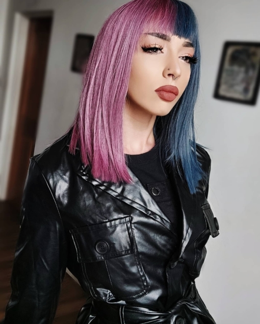 Half blue half lilac split straight bob wig. Poise is a soft and subtle take on the split colouring technique. Split straight down the middle so each colour falls either side of the centre parting at the front of the head. These two tones mix together at the back of the style. A denim blue and a deep lilac shade.