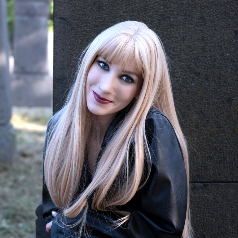 A long straight one-length wig that falls to the waist. This natural light honey blonde colour from roots to tips comes with a sleek blunt fringe.