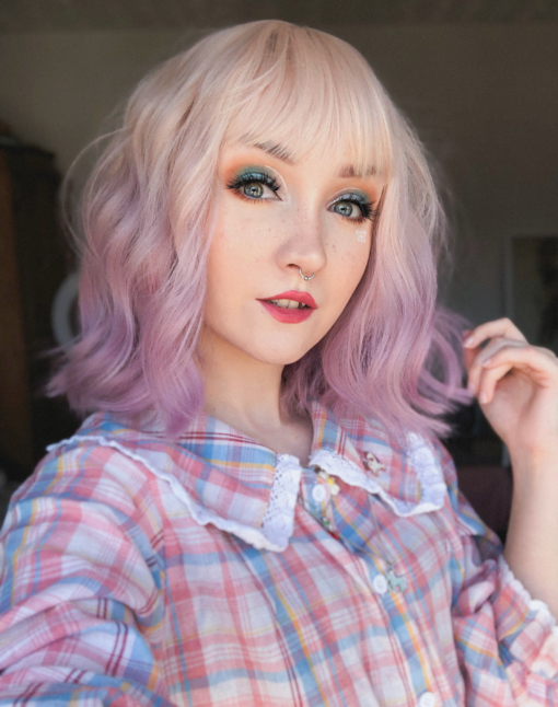 Buttercup has a natural twist of vanilla roots that carry a washed-out pastel pink. Styled in loose waves to give texture and body, with a wispy fringe to frame the face.
