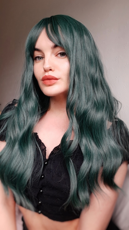 Green long wavy wig with bangs. Green hair don't care! Peacock carries a distinctive alpine green colour, to crown your head for nights out, or for mermaids just getting a new look. 