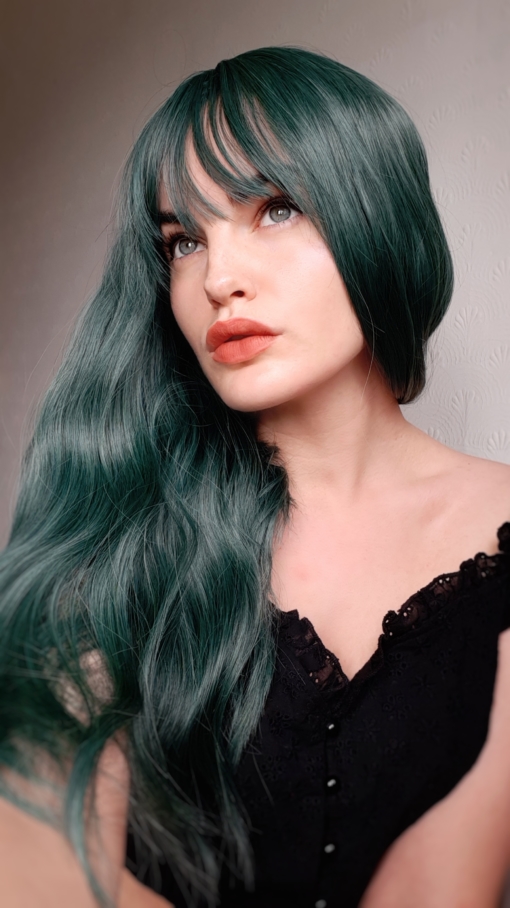 Green long wavy wig with bangs. Green hair don't care! Peacock carries a distinctive alpine green colour, to crown your head for nights out, or for mermaids just getting a new look.
