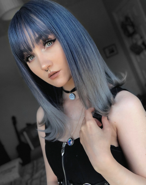 Dark blue and grey long straight wig with bangs. Venus has a mix of deep blue and grey tones that create this gorgeous colour. The ends are illuminated with a dip-dye effect of light grey with a curl.