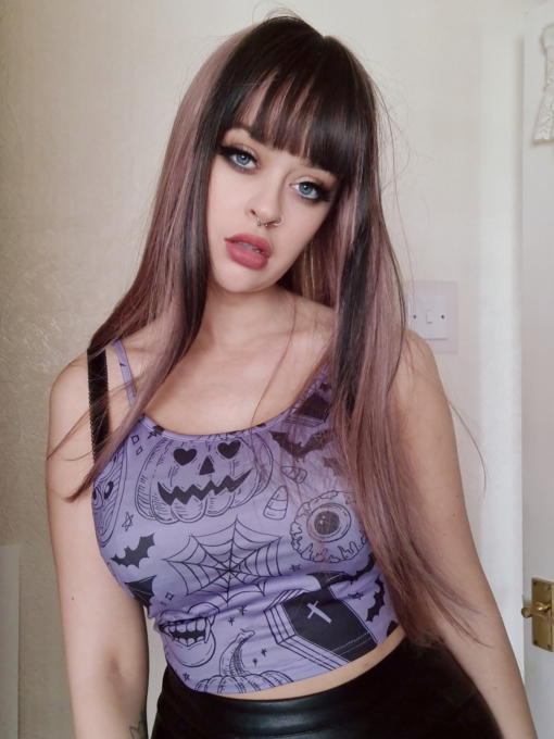 Lilac long straight wig with bangs. Bang on trend, Ballerina is a luscious mauve colour with a bold slice of a dark brown colour that falls on each side and carried through the fringe to frame the face. Long and sleek with layers for movement.