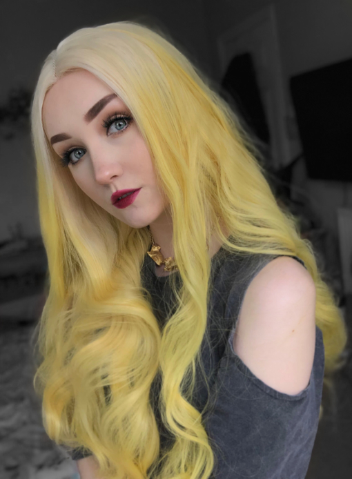 Yellow blonde long curly lace front wig. Mango comes in this eye-catching yellow blonde colour, with never-ending tumbling curls. The roots are a diamond blonde colour that blend into the lengths to create this unique colour.