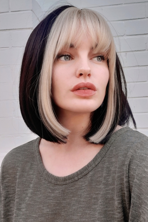Black/Brown with blonde streak straight bob with bangs. Pika has a distinctive highlight of blonde colour that runs through the fringe and each side of the face. A throwback to the 90s that looks like it's here to stay!
