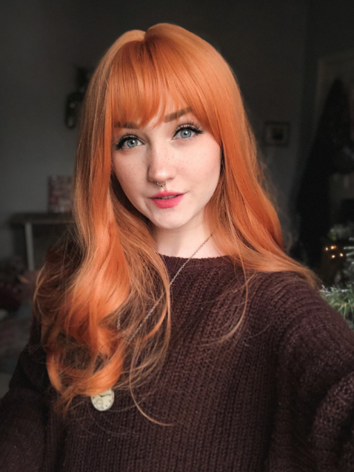 Sunbeam is an unusual orange colour blend of golden copper from roots to tips. A sleek style with gentle curls at the ends with a light fringe, produces this eye-catching look.