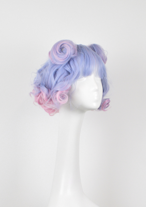 Curly short bob with bangs. Pastel blues and pinks combine to make this cute ringlet delight. This wig comes with two clips in pigtails for extra oomph! Alternatively you can just wear this style alone and let the colours do the talking. A full fringe frames the face.