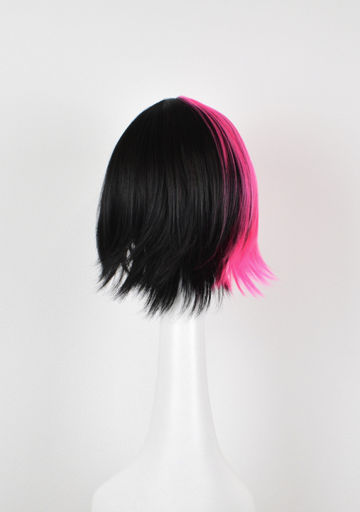 Pink and black split section straight bob wig with bangs. Galah takes on the dramatic colour divide. A vivid deep pink section from the centre parting, through the fringe, across to the ear, leaving the rest of the head a black colour. A straight blunt cut with a wispy fringe.