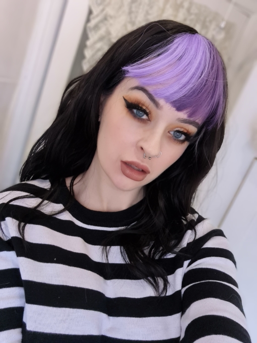 Multi-colour long wavy wig with bangs. Be one of a kind in Charoite, a unique natural twist. With cool black relaxed waves, with a bright fringe that carries the colours of purple and lilac.