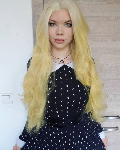 Yellow blonde long curly lace front wig. Mango comes in this eye-catching yellow blonde colour, with never-ending tumbling curls. The roots are a diamond blonde colour that blend into the lengths to create this unique colour.