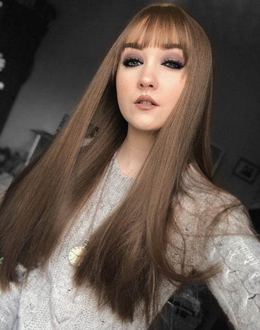 Brown straight long wig with bangs. Veronica is a beautiful natural colour of golden brown from roots to tips. A sleek style with long layers at the front with a light fringe.