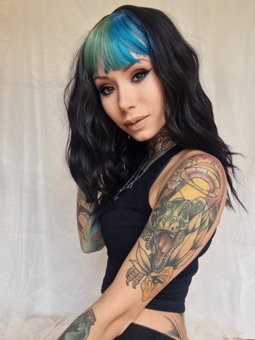 Multi-colour long wavy wig with bangs. Vibrant blue and teal adds a pop of colour to this grungy style. With it's just got out of bed waves. We are loving our collection of bright bangs. 
