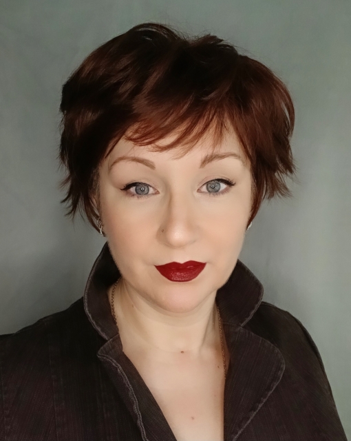 A cute pixie cut in a dark brunette colour. Sleek short layers are blow dried with a large barrel brush. Wear it forward or swept to the side away from the face.
