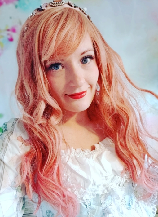 A gorgeous faded peach colour from the roots, with rosy pink dipped dye ends. Styled in loose tumbling curls, finished with a fringe that is light and airy.
