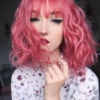 Pink bob wig with fringe. Add a little modern colour to a 1960s bob. Dusty Rose is a layered bob in a powder pink hue, with a 60s flick.