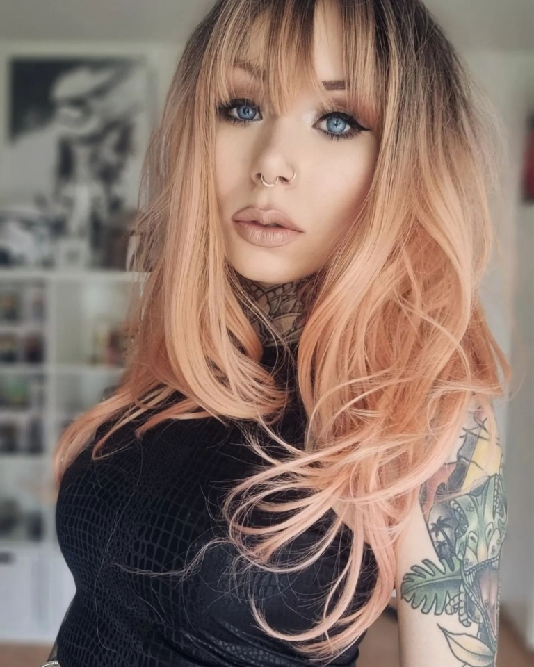 Be the belle of the ball in Flamingo! With its dark brown overgrown roots. A fresh peach sleek blow out style with a light airy fringe to frame the face.