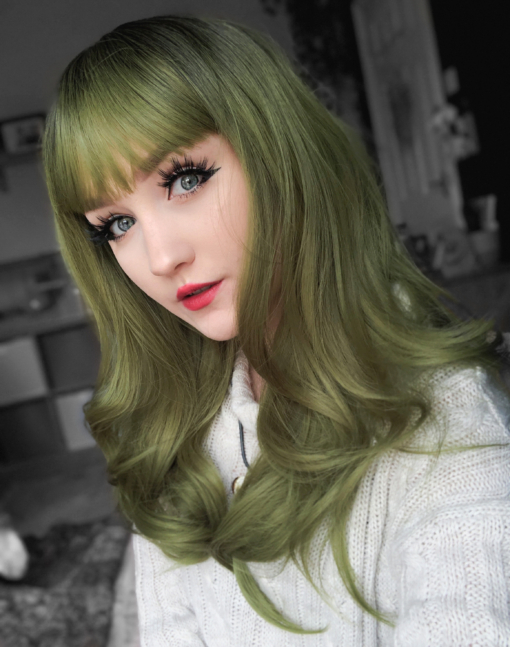 Green and brown long straight wig with bangs. Oracle takes green with a natural twist of dark brown shadowed roots. Long sleek layers finished in a classic blow out style. With a fringe to add softness to the face.