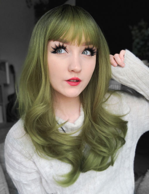Green and brown long straight wig with bangs. Oracle takes green with a natural twist of dark brown shadowed roots. Long sleek layers finished in a classic blow out style. With a fringe to add softness to the face.