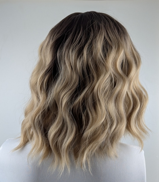 Mocha - Lush Wigs UK This bob is coloured in a honey blonde tone with brown shadowed roots. That gives a natural feel to the look. A loose wave and a sleek fringe finishes the look.