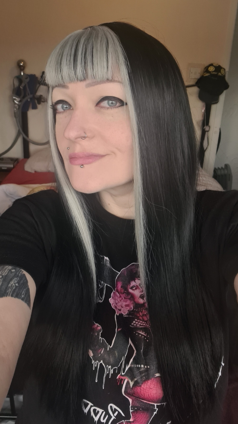 Billie - Lush Wigs UK This sleek and dead straight long medium length style comes in a warm black colour. With a money-penny highlight of light grey in the fringe and each side of the face.