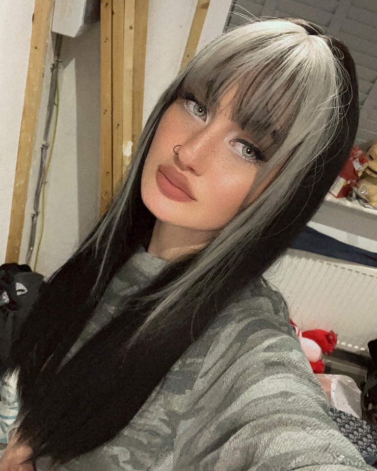 Billie - Lush Wigs UK This sleek and dead straight long medium length style comes in a warm black colour. With a money-penny highlight of light grey in the fringe and each side of the face.