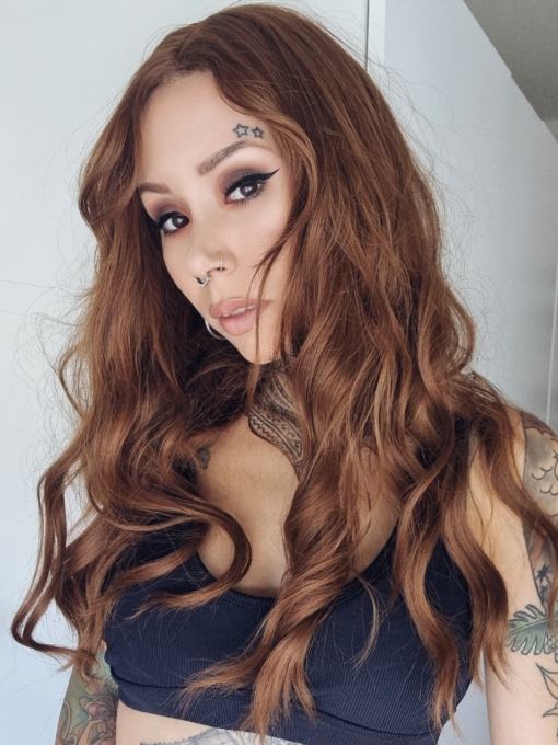 Inspired from looks of the 60s and 70s era. Tabitha is a natural golden brown hue from roots to tips. Long relaxed curls and curtain bangs that fall to the jawline, makes this style versatile to play with different looks.