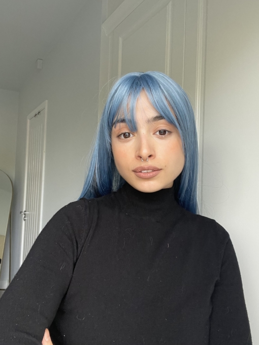 Bluejays mixture of baby blue hues from roots to tips, with blocks of charcoal for a pop of smokey colour. Sleek with layers for fullness, a light fringe frames the face. 