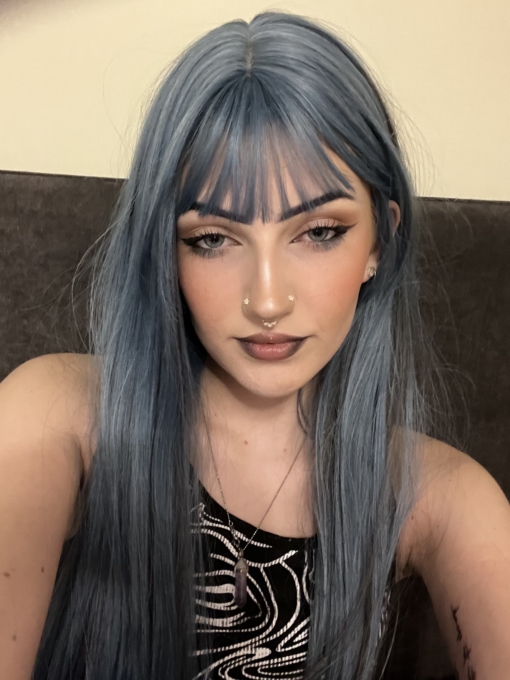 A mixture of pastel and midnight blue hues from roots to tips. With slices of black streaks underneath for a peek-a-boo effect. Straight and sleek with layers for fullness. A light fringe frames the face.