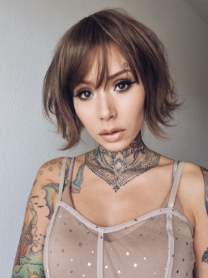 This jaw-skimming bob, styled with a gentle flick curl at the ends. Short choppy layers add volume. With a sleek light fringe. A colour mix of warm light browns from roots to tips. Easy to wear and maintain.