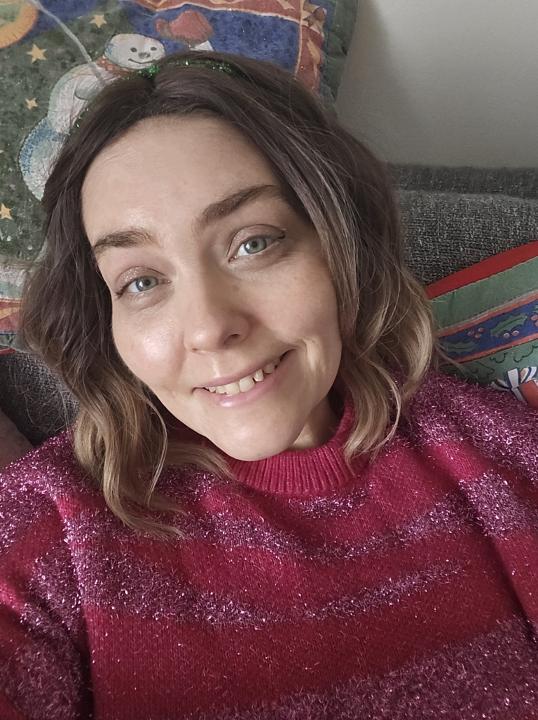 A fringeless A-line bob styled in a loose wave. Warm brown tones from the roots, blend into a dark blonde tint on ends of the hair. A fresh natural look that is casual and easy to maintain.