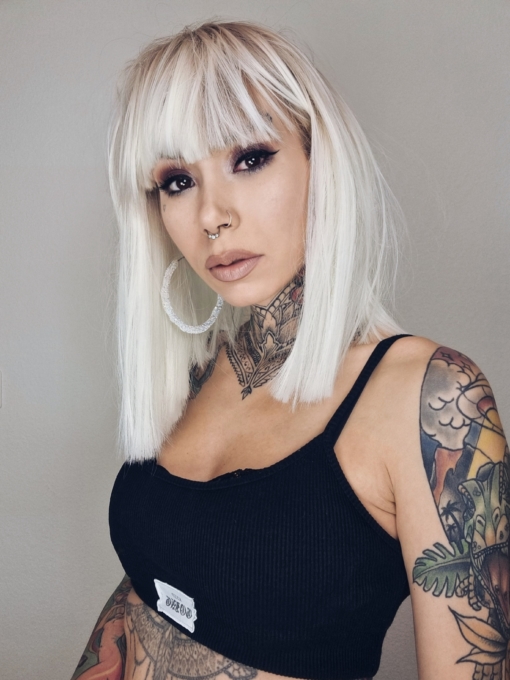 Lorna is a rework of the platinum blonde colour with a sprinkle of sandy blonde roots, creating a natural feel. Poker straight, long one length bob (lob) with a sleek full fringe.