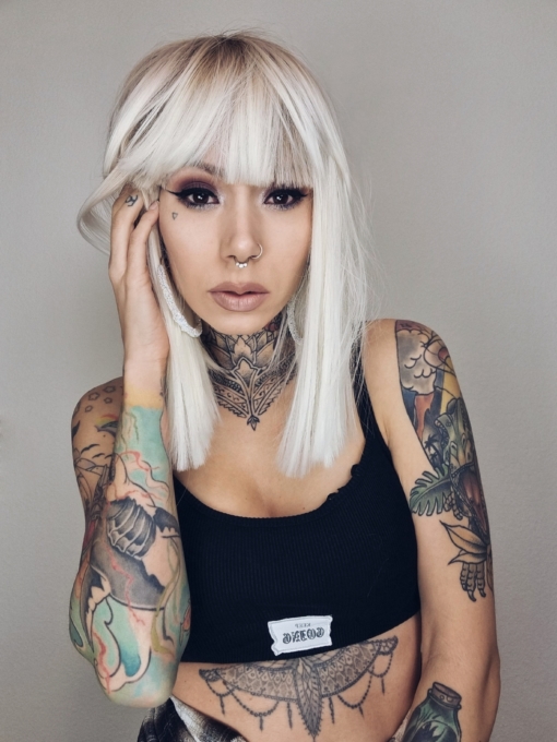 Lorna is a rework of the platinum blonde colour with a muted  lemon undertone. A sprinkle of sandy blonde roots, creating a natural feel. Poker straight, long one length bob (lob) with a sleek full fringe.