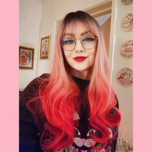 Sorbet has all the best shades of pink, brown shadowed roots blend into a flamingo pink. Melting into an ombre of deep rouge rose. Sleek from the top with a full fringe. The style falls to the waist in loose curls.