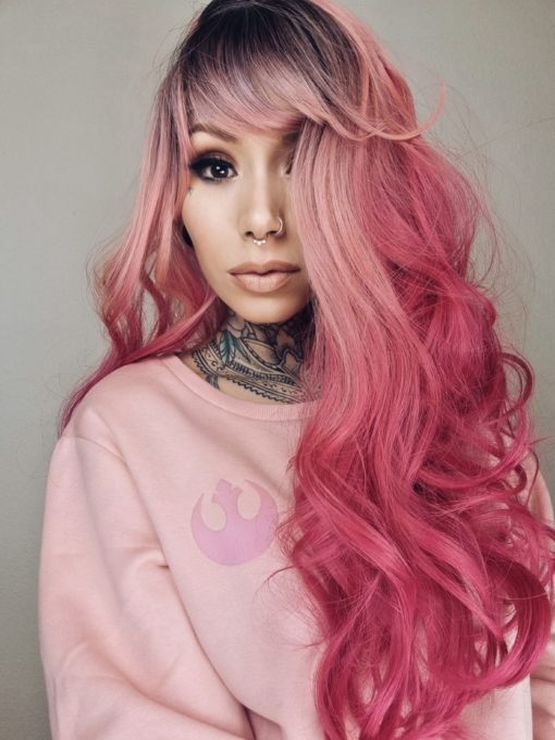 Sorbet has all the best shades of pink, brown shadowed roots blend into a flamingo light pink, that blends into an ombre of deep rouge rose. Sleek from the top with a full fringe. The style falls to the waist in loose curls.