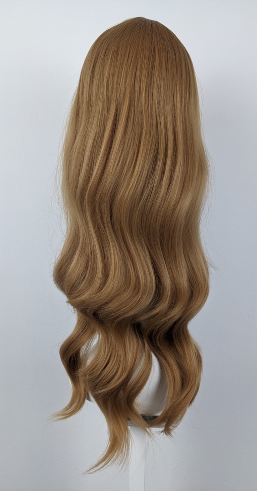 Golden tones make Della. With its relaxed tousled waves that fall to the waist. Deep honey blonde hues give a golden tone for warmth. This gorgeous colour runs from roots to tips. A sleek airy fringe finishes the look.