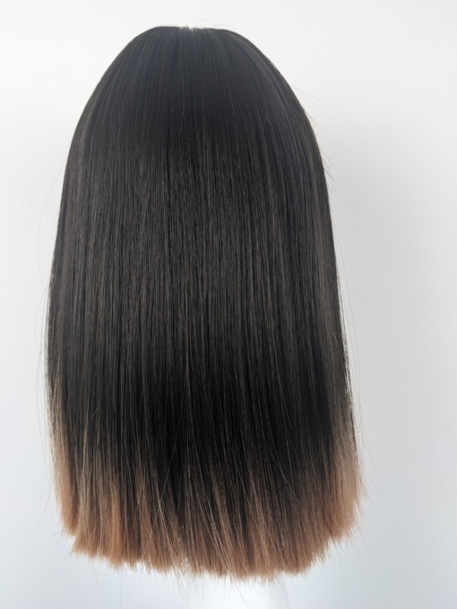 Zanya is a colour blocking twist. This natural mix of dark cocoa brown from the roots has a distinctive dip dye sunset blonde at the tips. Sleek long bob (lob) style with a light airy fringe.