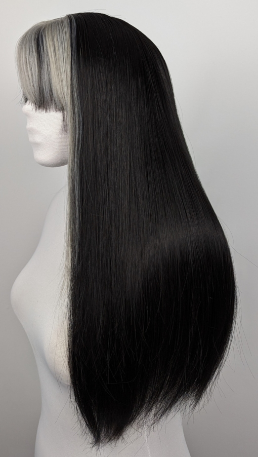 Billie takes the money piece colouring technique, with an earthy grey tone thats carried through the fringe. Long sleek classic black layers add texture and movement to the style.