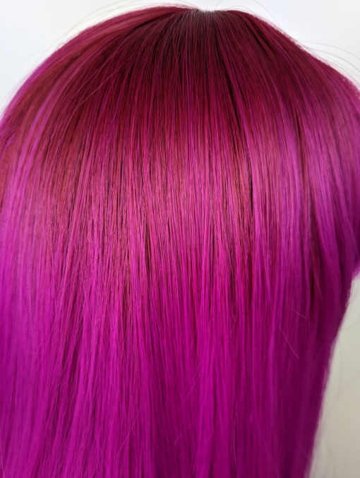 Pink lob with dark magenta roots melt into a shocking pink in a dead straight style. Long Lob with a full fringe to peep from under.