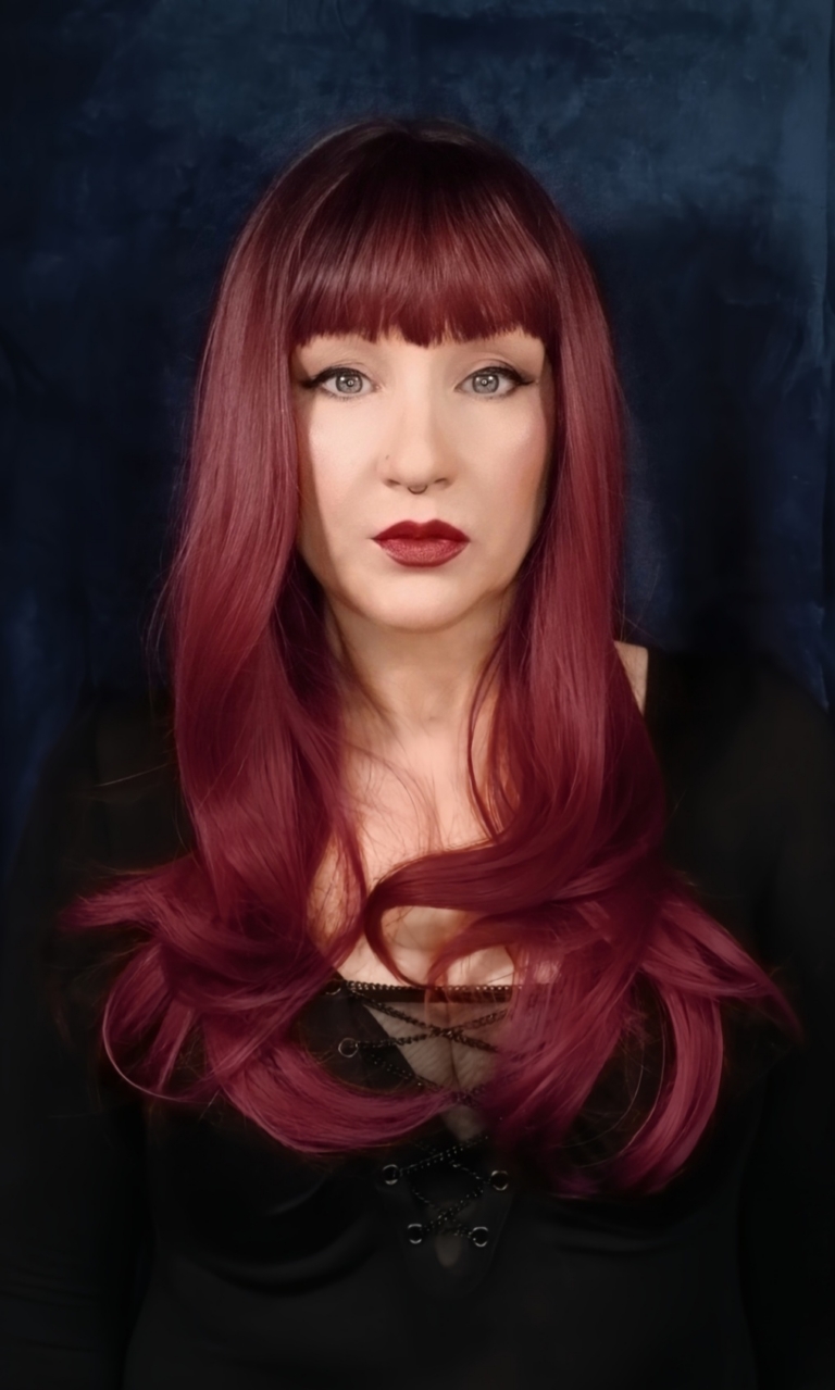 This sleek style comes in muted merlot red wine colour with warm black shadowed roots for a natural feel. Cut into long layers that fall to the waist. Finished in a barrel brush blow out, with a lightweight sleek fringe.