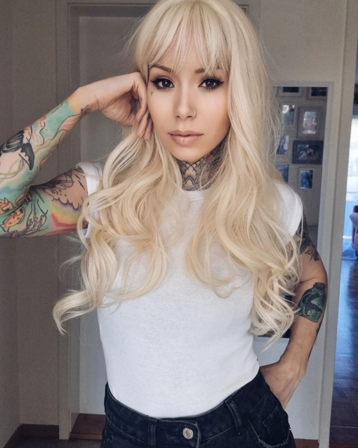 Waikiki gives effortless bohemian vibes, this light bleach blonde tone from roots to ends. Styled sleek from the crown of the head into long invisible layers with loose barrel curls. A long sleek fringe adds softness around the face.