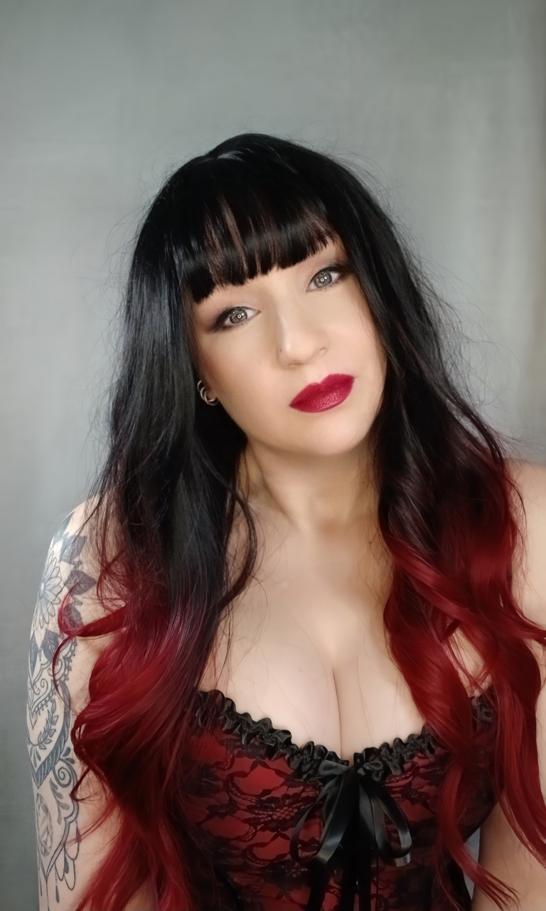Black and red go together in perfect harmony. Cinnabar is our latest ombre of cool black and wine red. Styled in a blow out with long layers for movement. A blunt fringe frames the face.