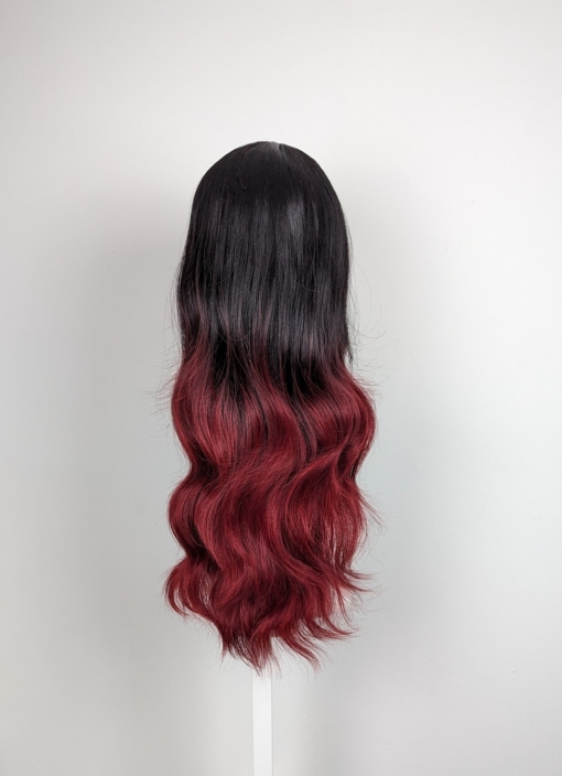 Black and red go together in perfect harmony. Cinnabar is our latest ombre of cool black and wine red. Styled in a blow out with long layers for movement. A light fringe frames the face.